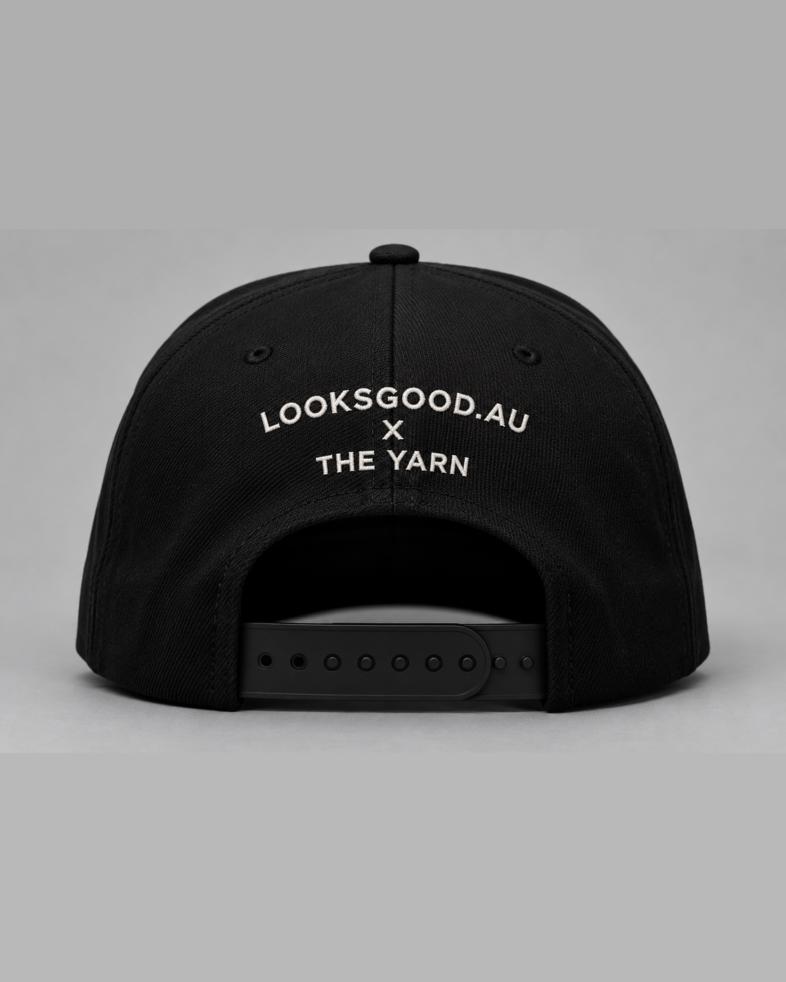 Rear view showing LOOKSGOOD.AU × THE YARN embroidery and premium matte-black snapback closure.